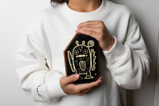 child's hands holding a handcrafted wooden companioni called a Twilight Talisman