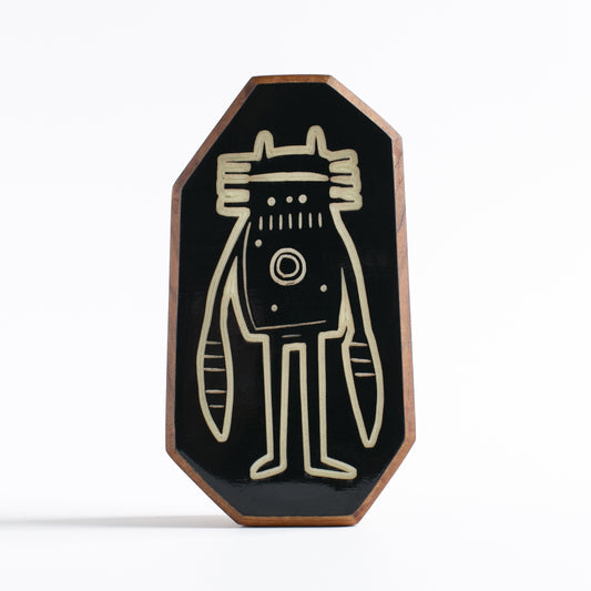 Handcrafted wooden glow-in-the-dark talisman featuring Blizznek the robot guardian
