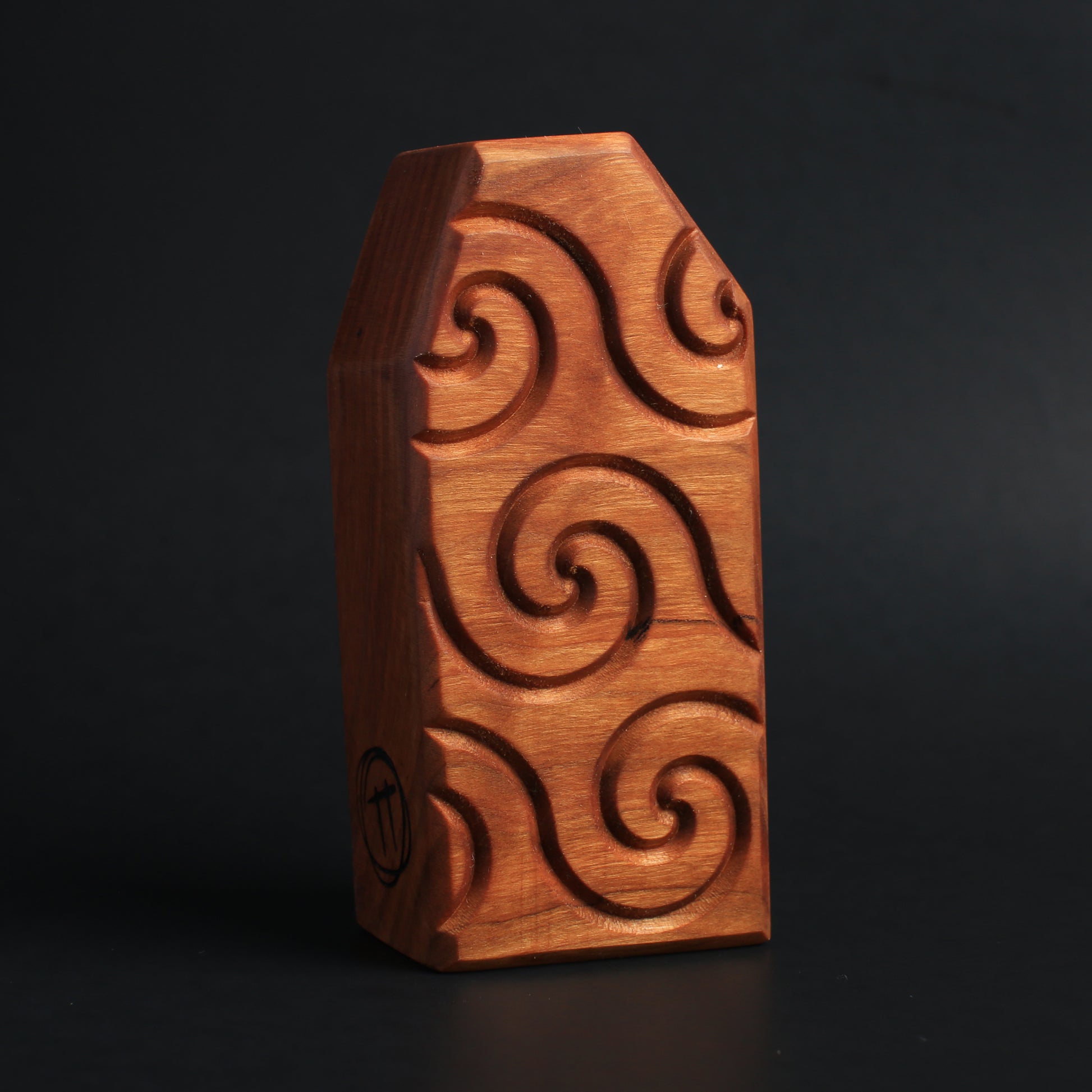 Back view of Floopfin showcasing the swirl timber pattern and natural wood finish placed against a dark background