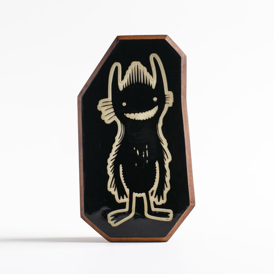 Handcrafted glow-in-the-dark talisman featuring Nebulax the forest spirit monster