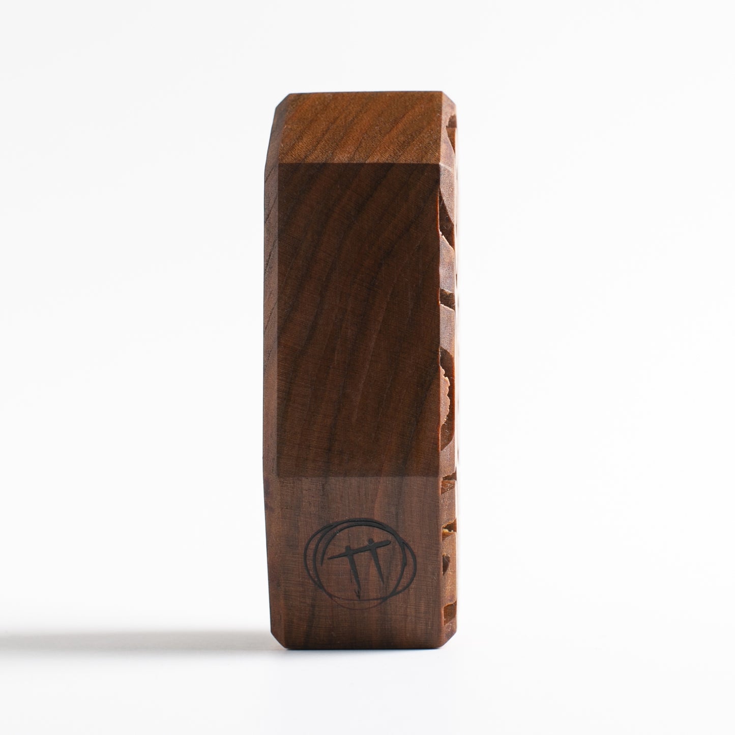 Handmade wooden talisman of Plazmorp emitting a radiant light barrier at night