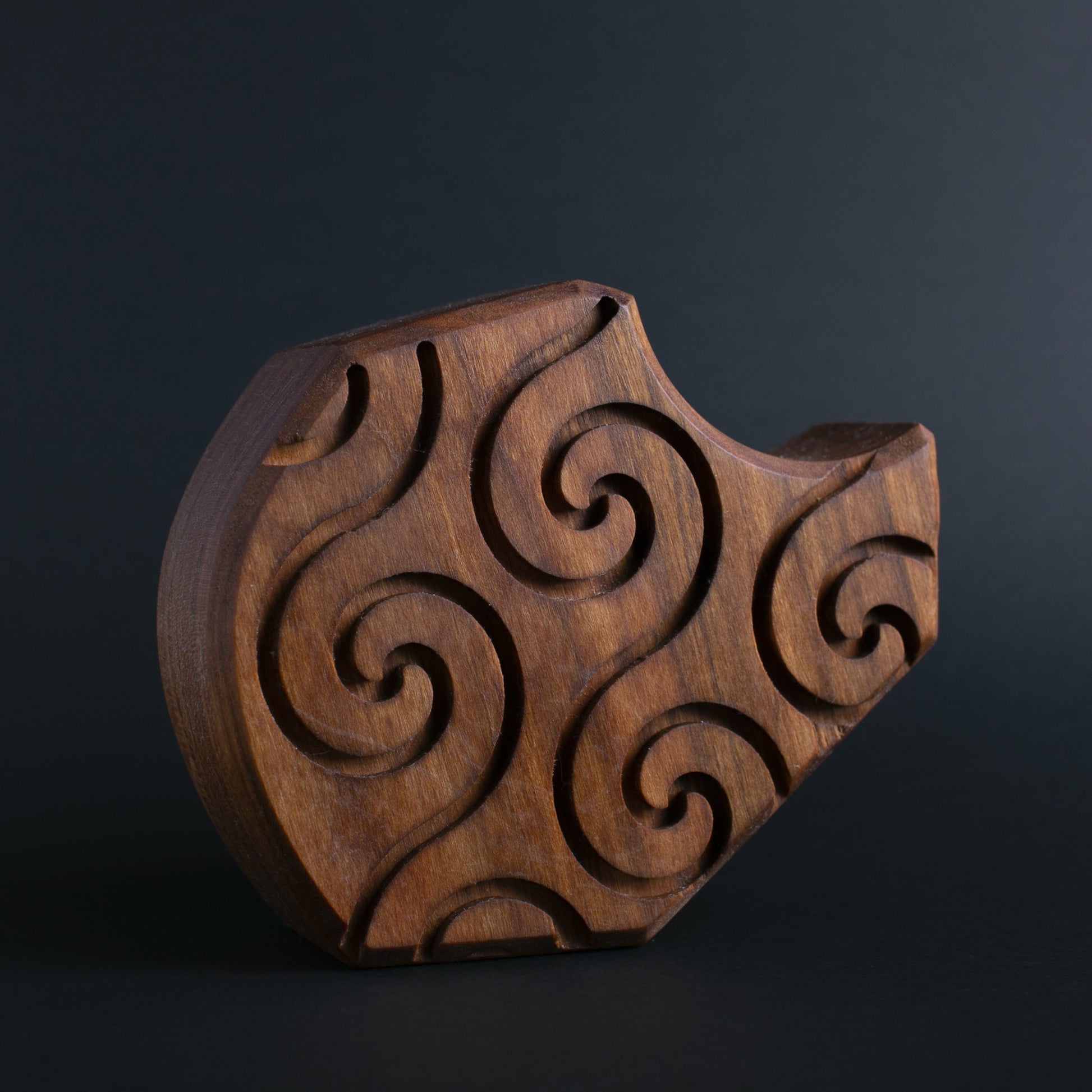 Glow-in-the-dark wooden talisman of Plonkzoid ensuring peaceful and safe sleep