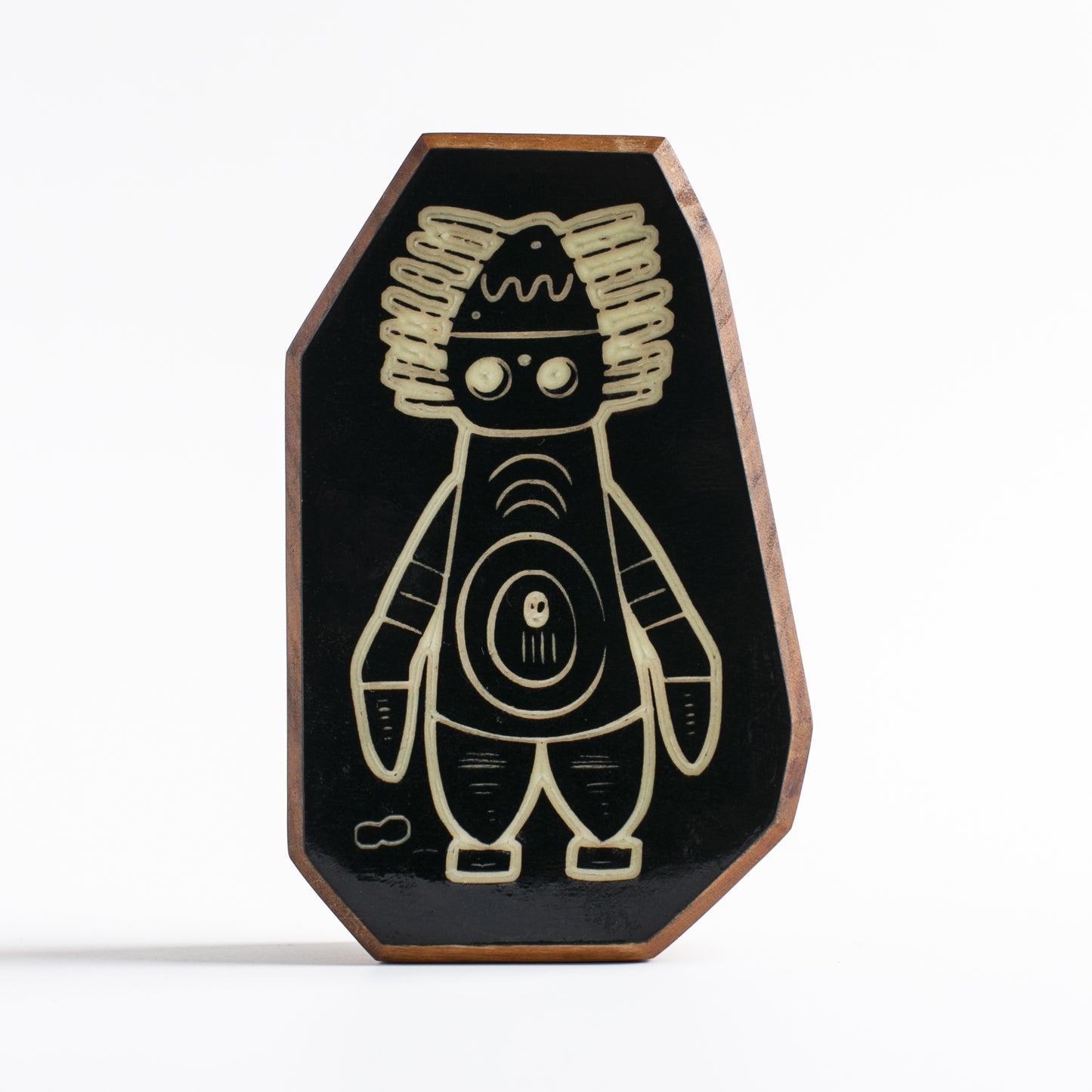 Handcrafted glow-in-the-dark talisman featuring Pyronoid the high-tech mechanical guardian