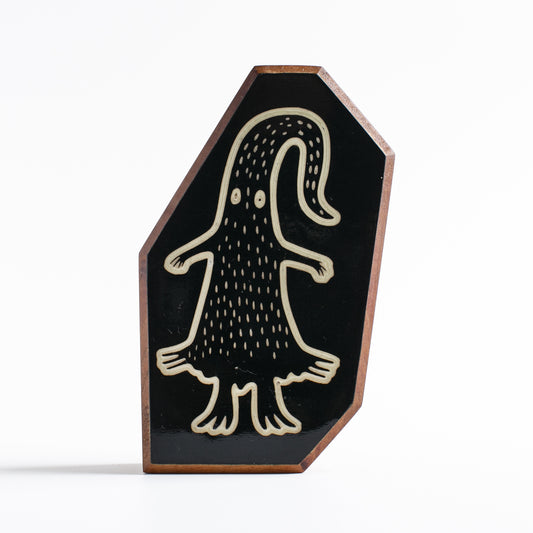 Handcrafted glow-in-the-dark talisman featuring Quibblex the whimsical forest spirit