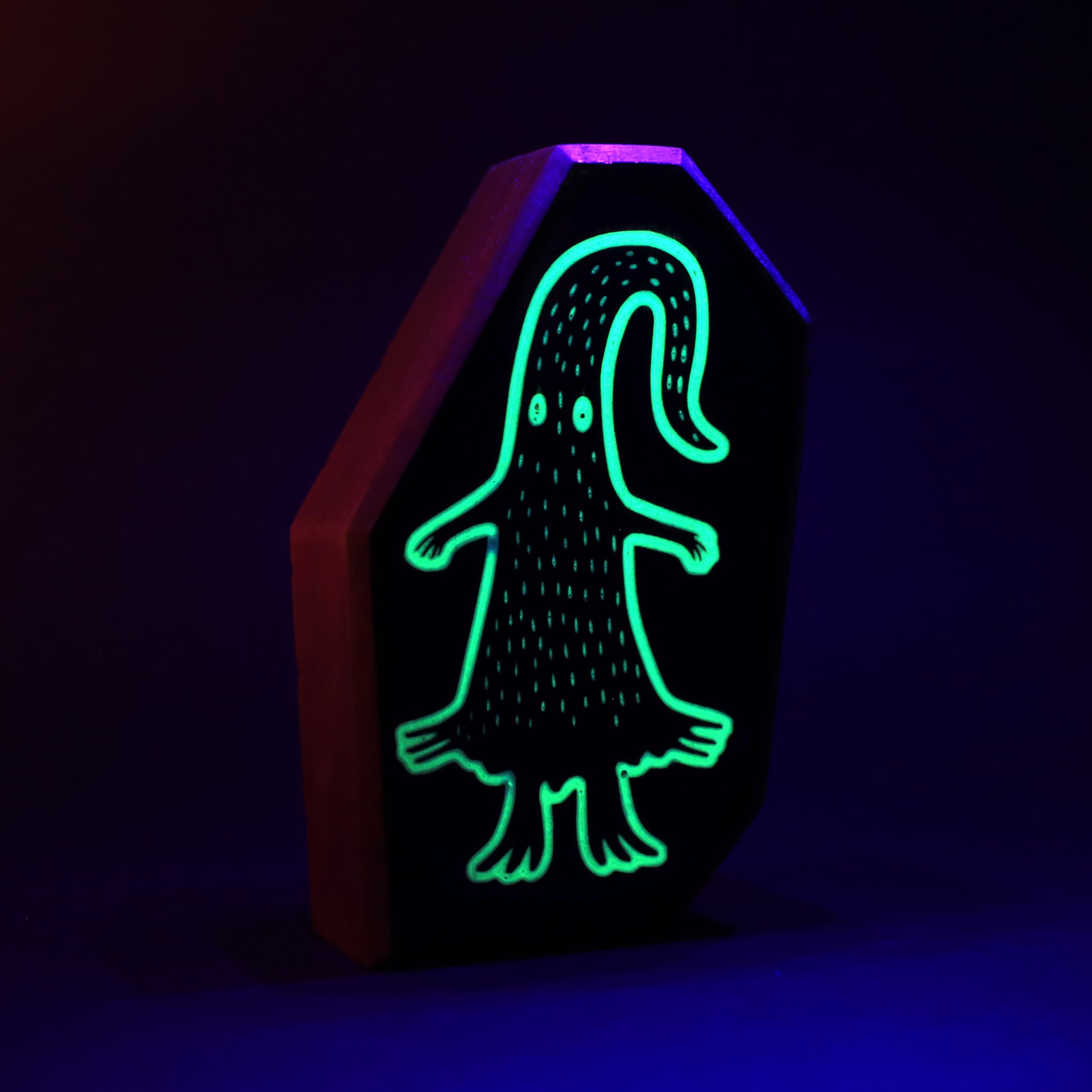 Quibblex wooden charm glowing softly to form a magical protective light barrier