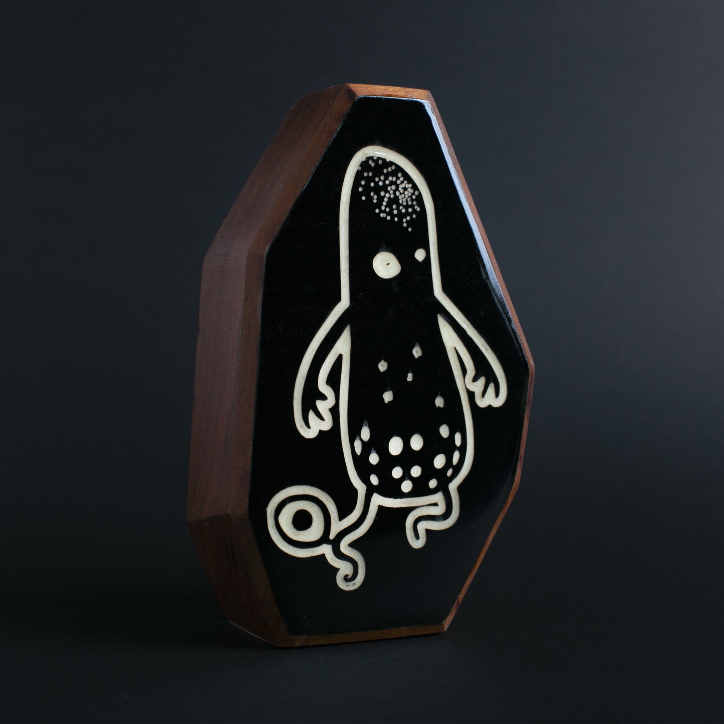 Cherry wood glow talisman featuring Snorble the playful water protector