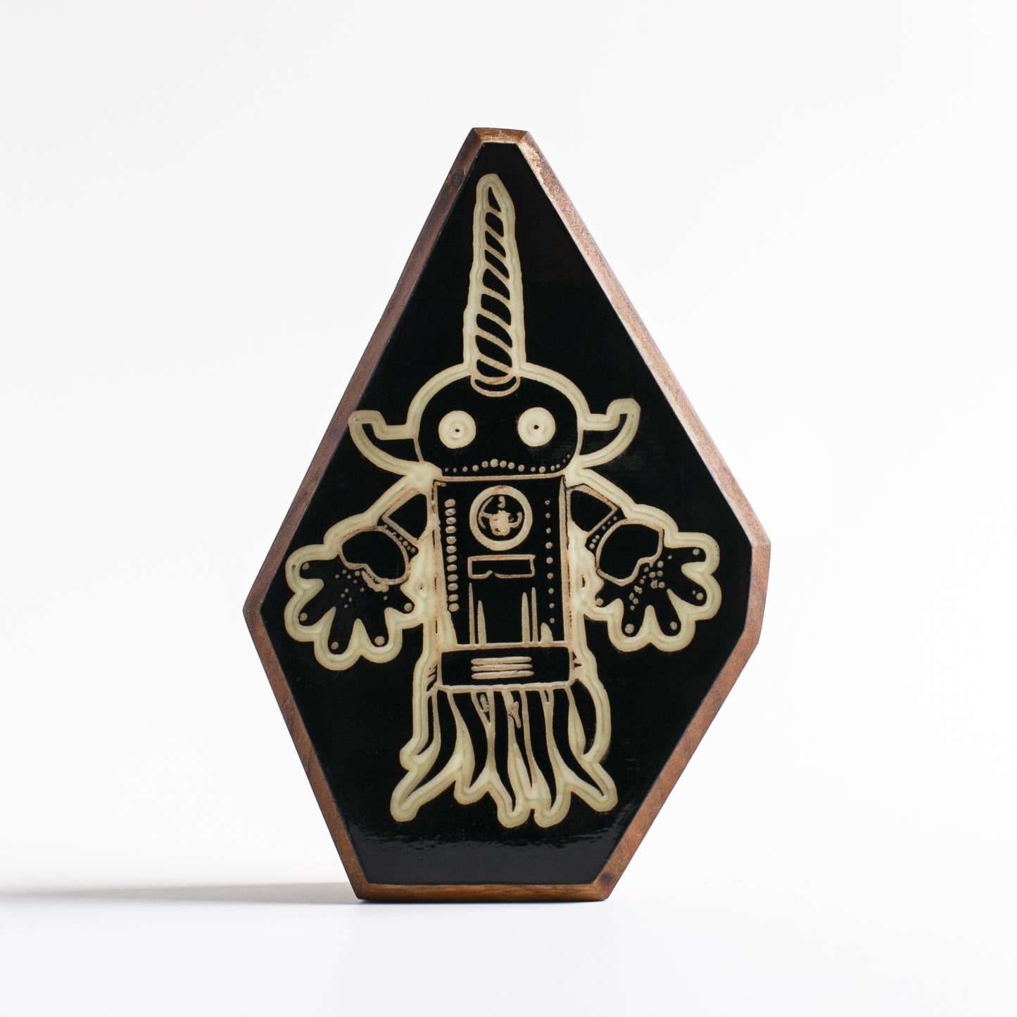 Handcrafted glow-in-the-dark talisman featuring Squibnik the part-squid, part-narwhal protector