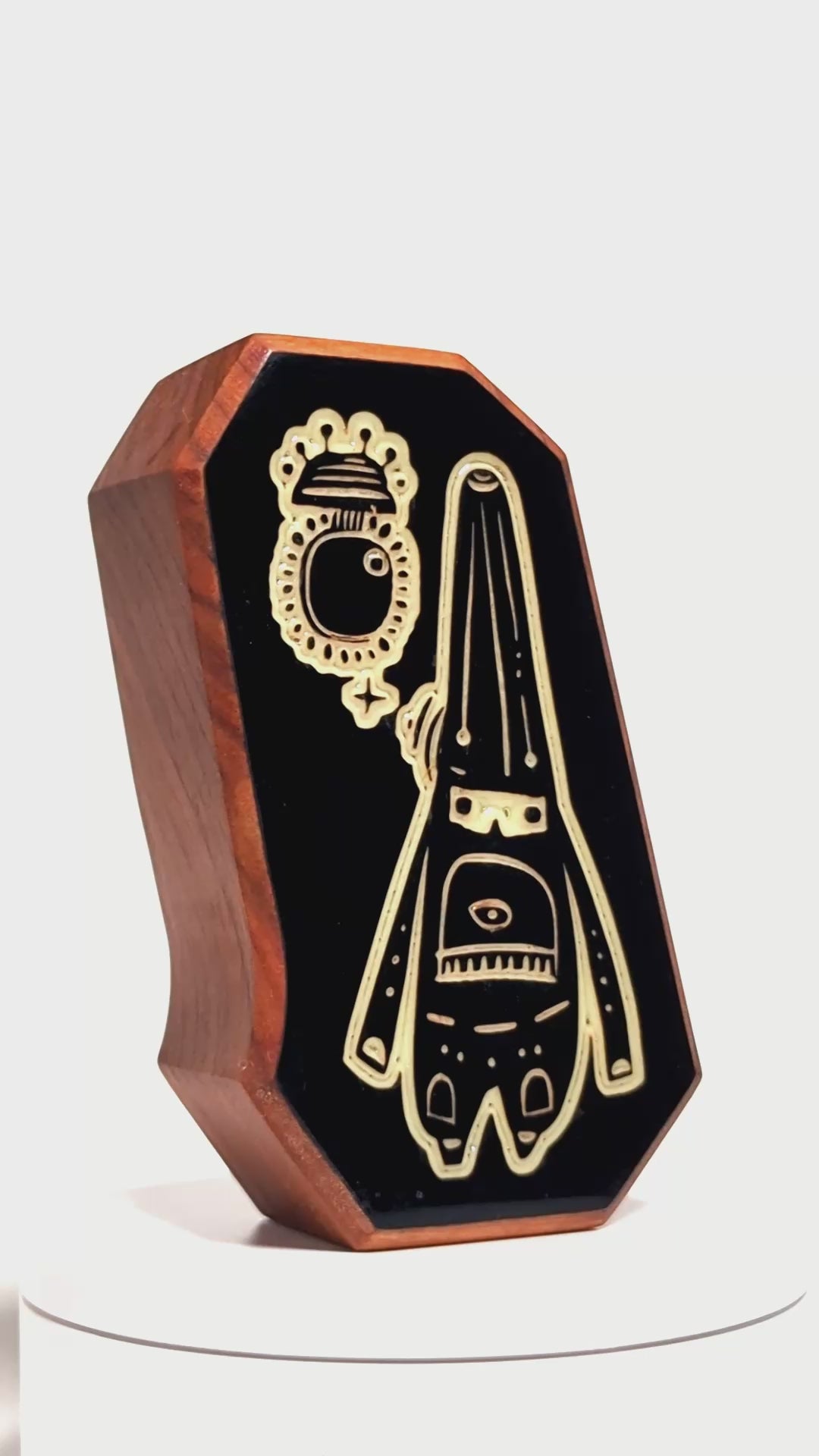 Wooden charm featuring Glimbop and Quazglitz glowing softly to soothe nighttime worries