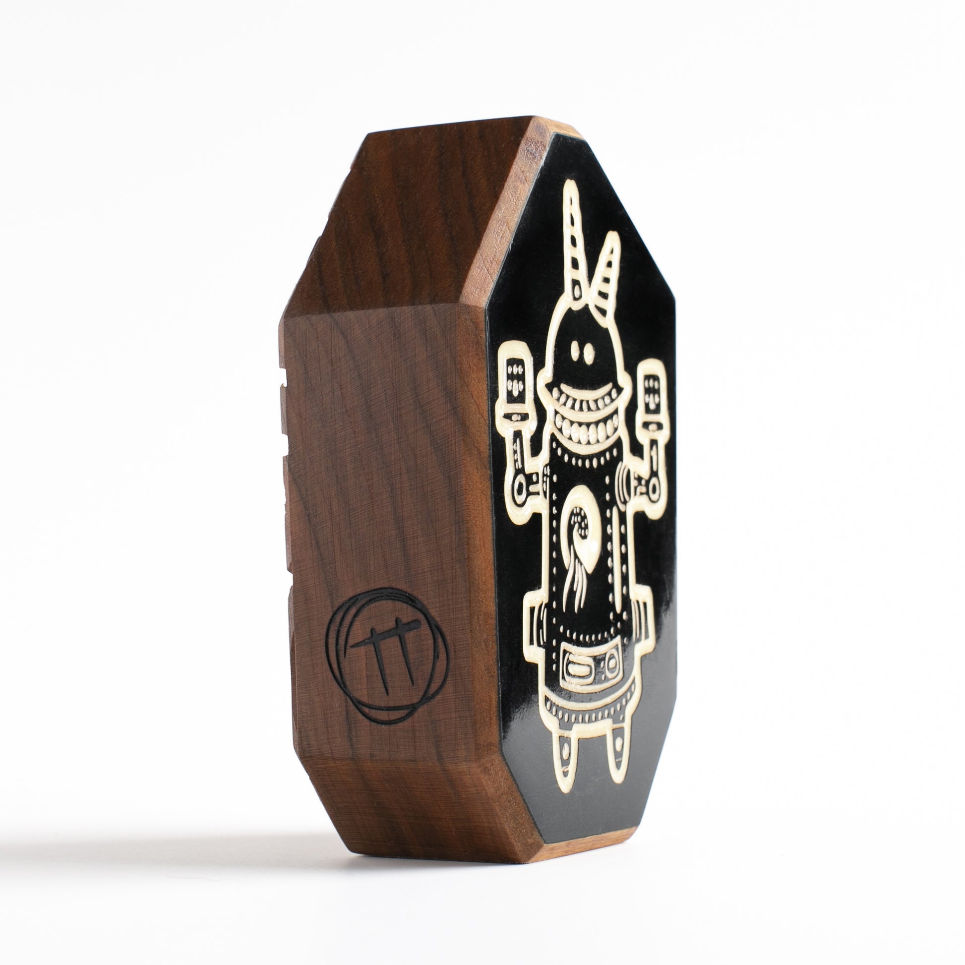 Handmade wooden talisman of Buzznork, glowing brightly to protect against the dark

