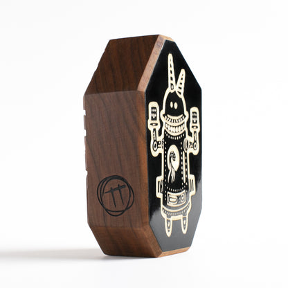 Handmade wooden talisman of Buzznork, glowing brightly to protect against the dark
