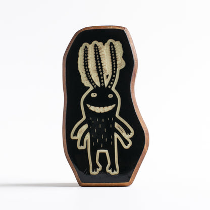 Handcrafted glow-in-the-dark talisman featuring Fluxoid the ancient space traveler
