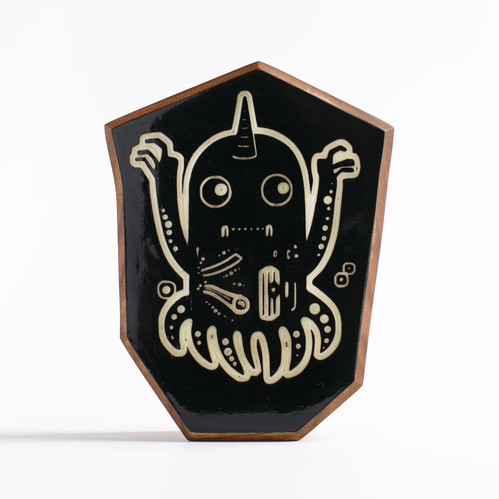 Handcrafted glow-in-the-dark talisman featuring Jellywobble the space-faring cuttlefish
