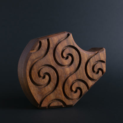 Glow-in-the-dark wooden talisman of Plonkzoid ensuring peaceful and safe sleep

