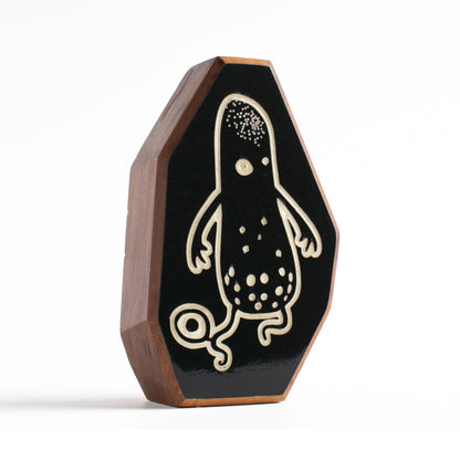 Cherry wood talisman with Snorble design offering kids bedtime comfort and safety

