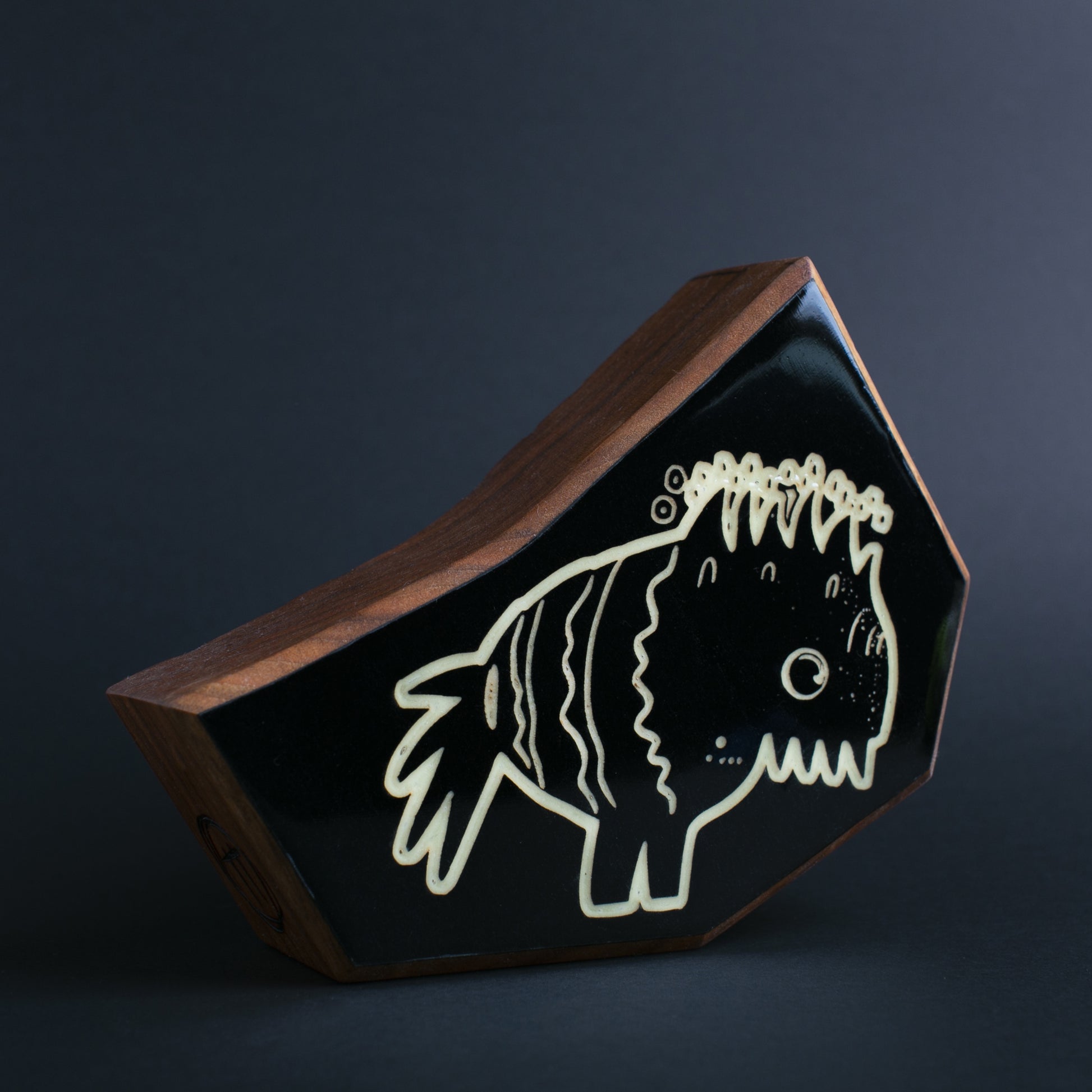 Cherry wood glow talisman featuring Snorfblip the dual-environment protector
