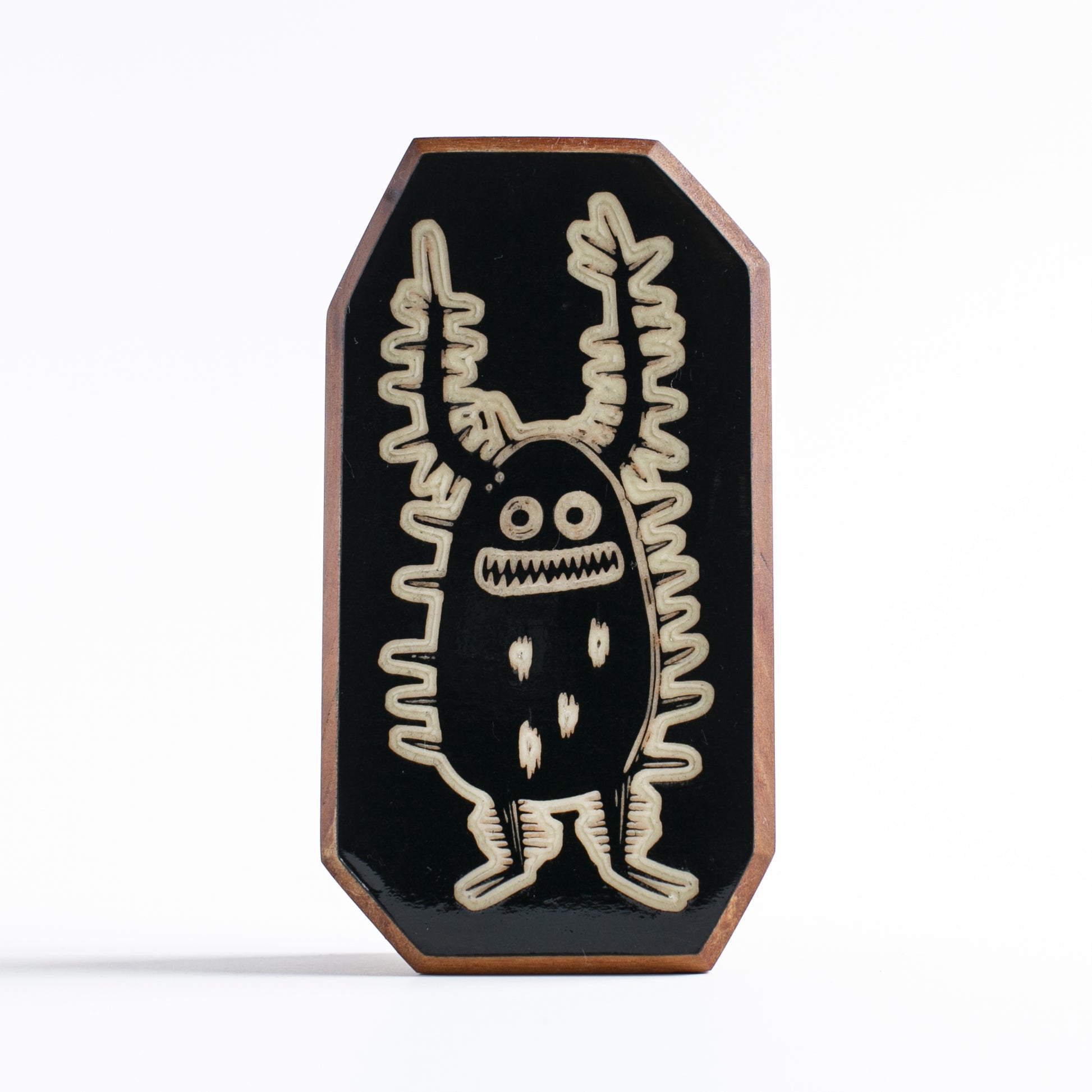 Handcrafted glow-in-the-dark talisman featuring Zorplix the fearless forest monster
