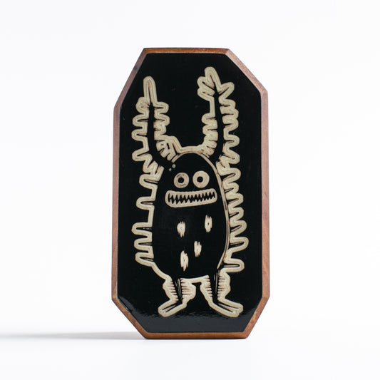 Handcrafted glow-in-the-dark talisman featuring Zorplix the fearless forest monster
