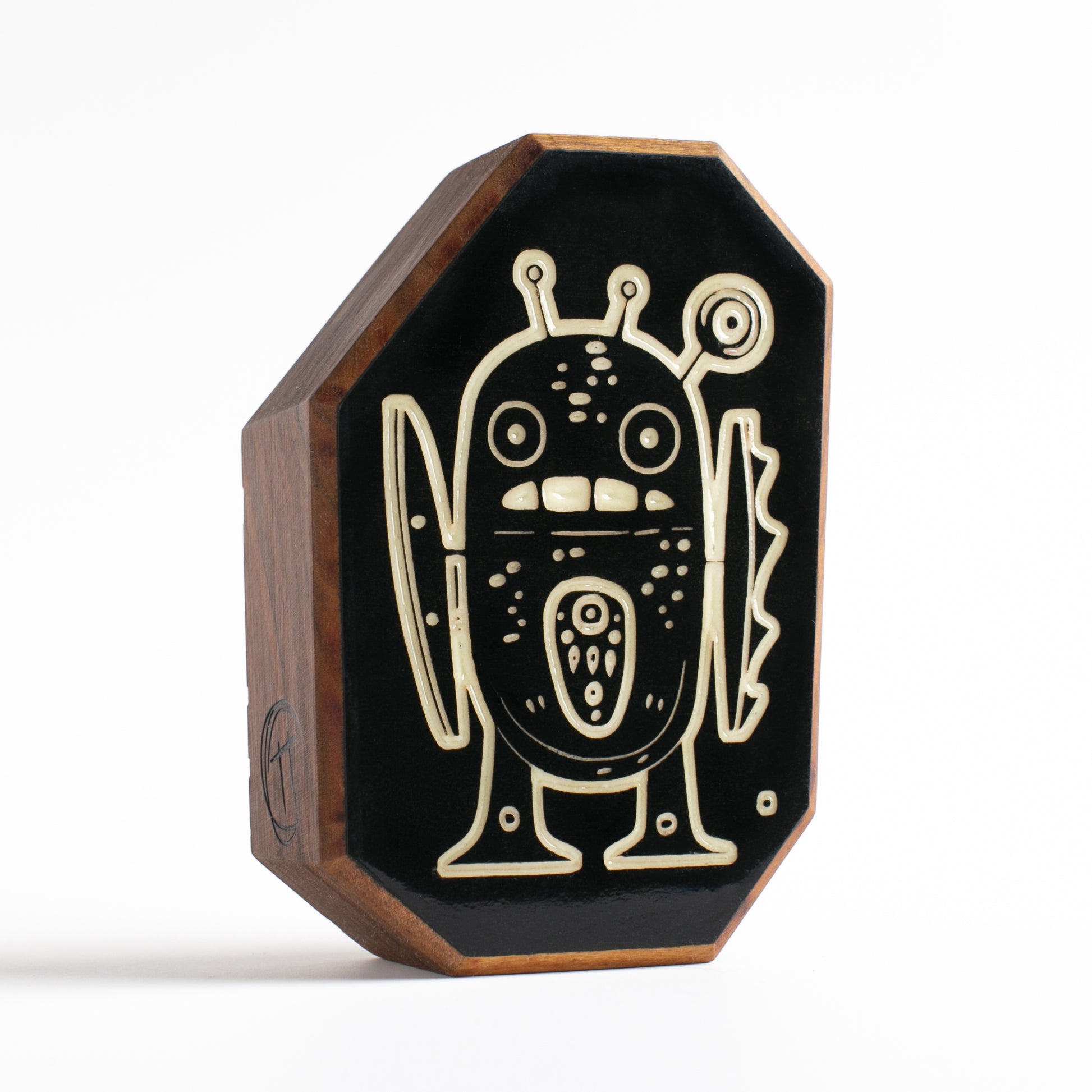 Cherry wood talisman with Zorpwob design offering kids nighttime safety and comfort
