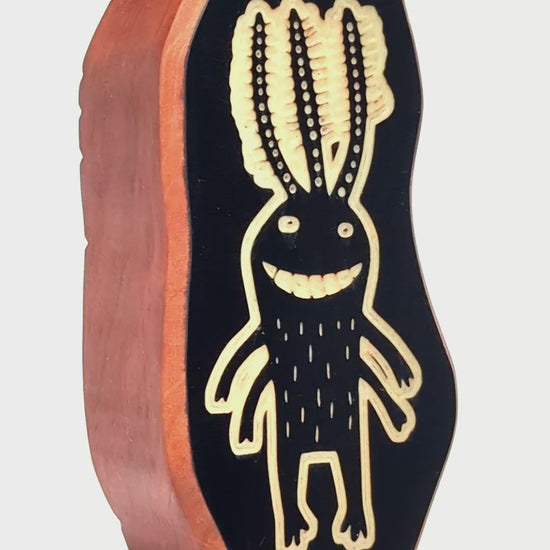 Wooden guardian Fluxoid glowing softly to ward off shadows at night
