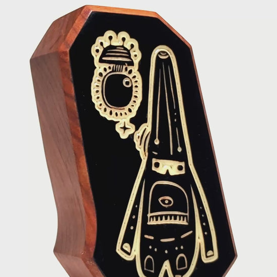 Wooden charm featuring Glimbop and Quazglitz glowing softly to soothe nighttime worries
